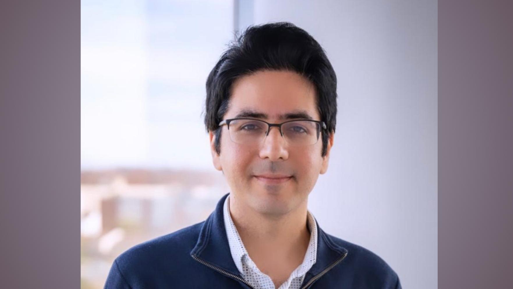 soheil smiling in glasses and blue shirt