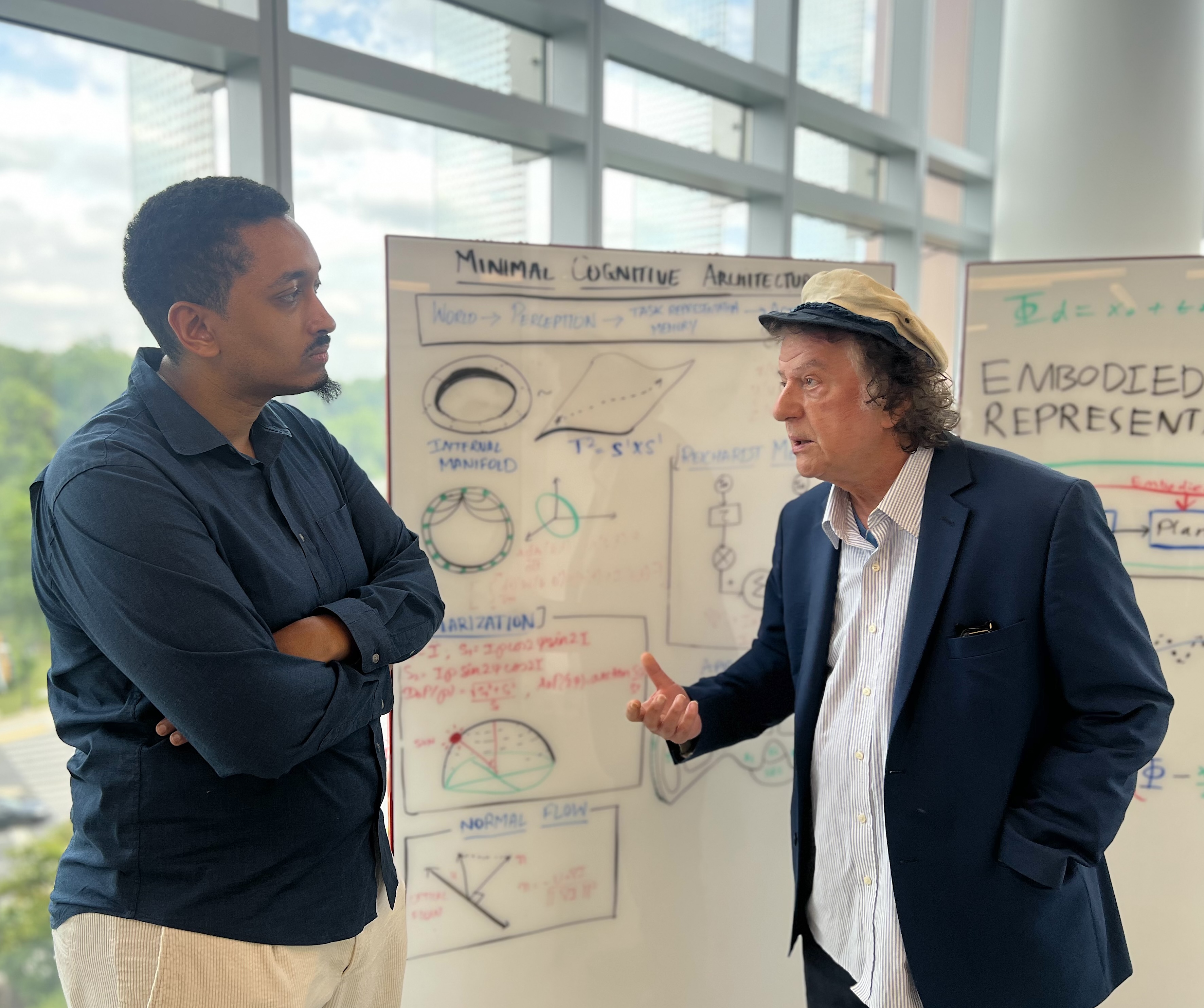 Yiannis Aloimonos (right) discusses concepts in embodied intelligence and machine perception with Eadom Dessalene. 