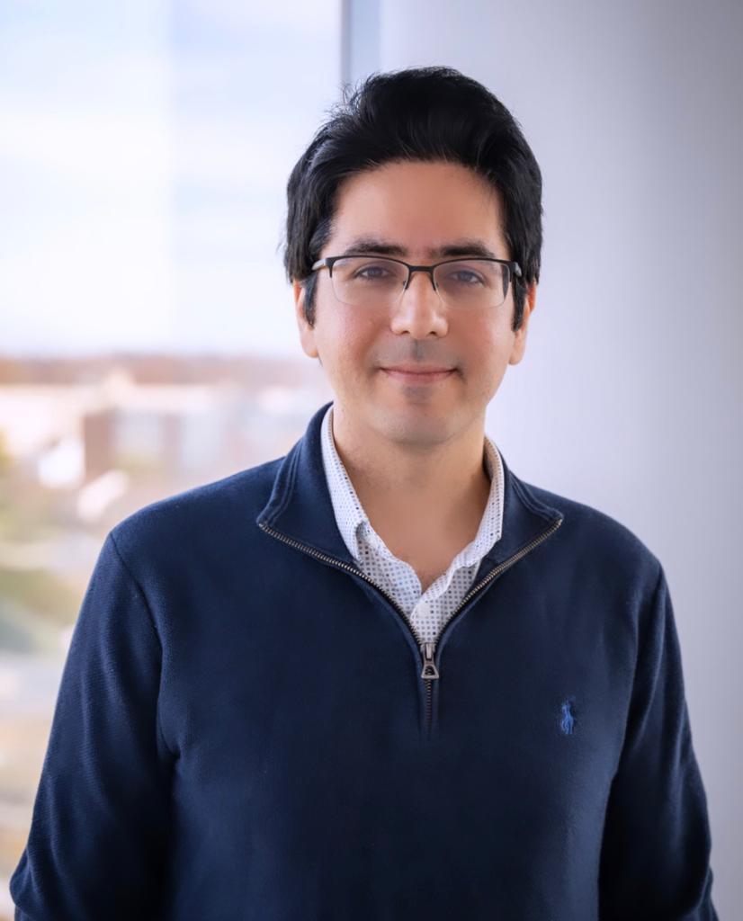 Soheil smiling in glasses and blue jacket