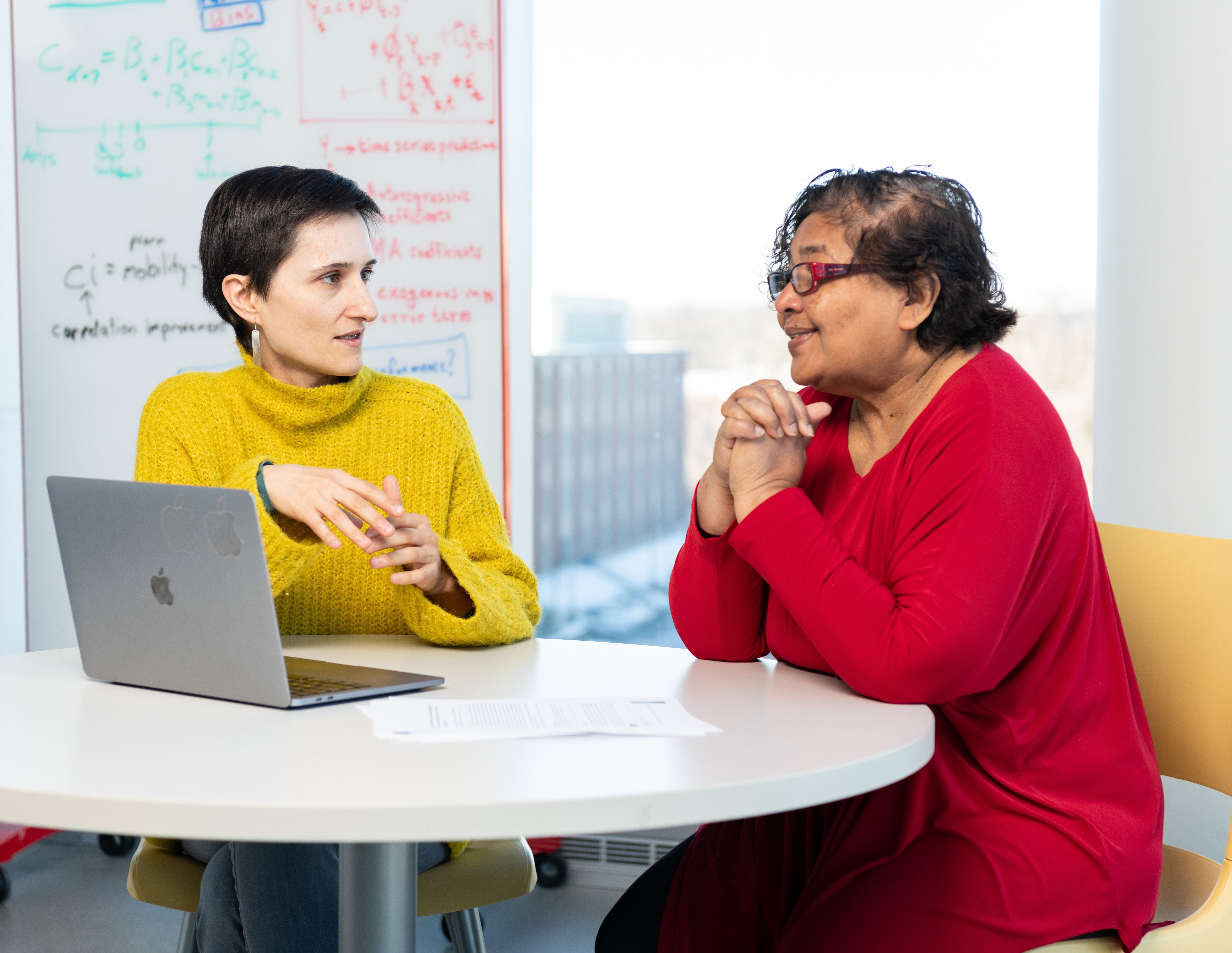 Vanessa Frias-Martinez sits across from Louiqa Raschid as the two engage in a discussion. 