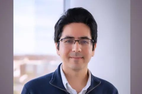 soheil smiling in glasses and blue shirt