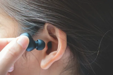 earbud being put in ear