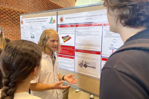 Jarrett Nelson, a rising senior majoring in computer science and minoring in physics and math at Utah Valley University, explains his recent work involving quantum simulations using lasers at a poster session sponsored by the University of Maryland Office of Undergraduate Research.