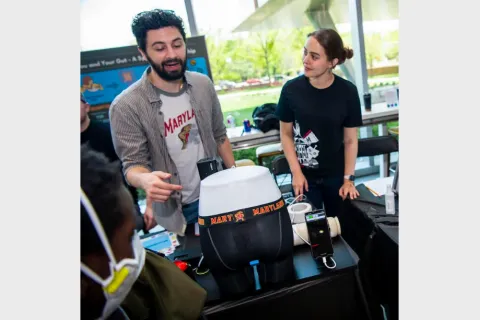 Research Group presenting work at a table