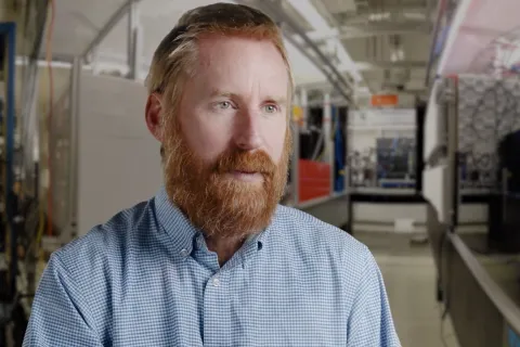 Ian Spielman speaks in an industrial setting.