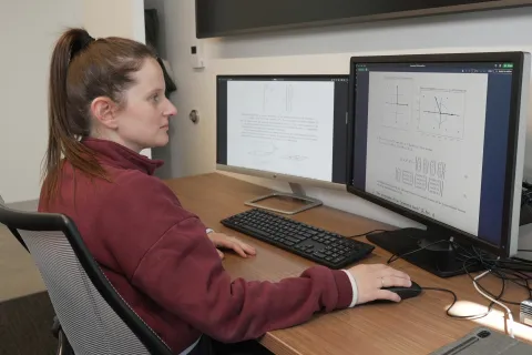 Natalie Lang working on computers