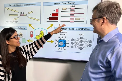Nazifa Ahmed Moumi pointing at a presentation containing machine learning models and metagenomic diagrams with Mihai Pop