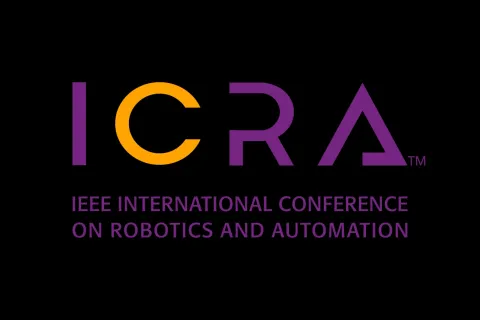 Logo for ICRA (IEEE International Conference on Robotics and Automation) featuring stylized purple and orange text on a black background.