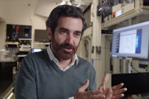 Mohammad Hafezi sits in a laboratory setting, gesturing with his hands while speaking.