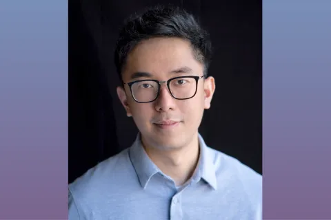 A headshot of Alan Liu. He wears glasses and a light blue collared shirt.