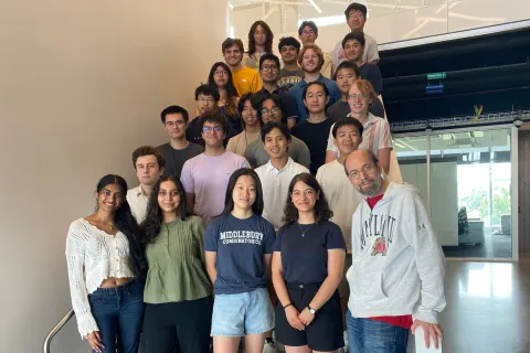 Participants in the 2025 REU-CAAR program gather on a staircase with principal investigator William Gasarch (front right) at the University of Maryland.