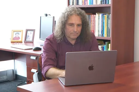 Philip Resnik sits at desk with laptop