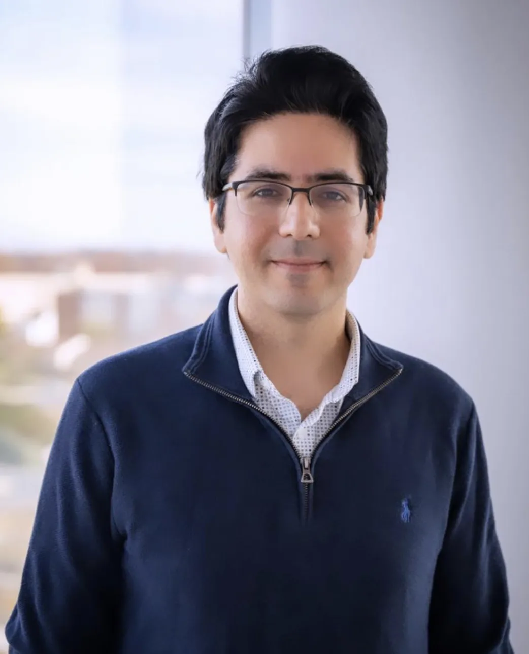 man with glasses in blue shirt