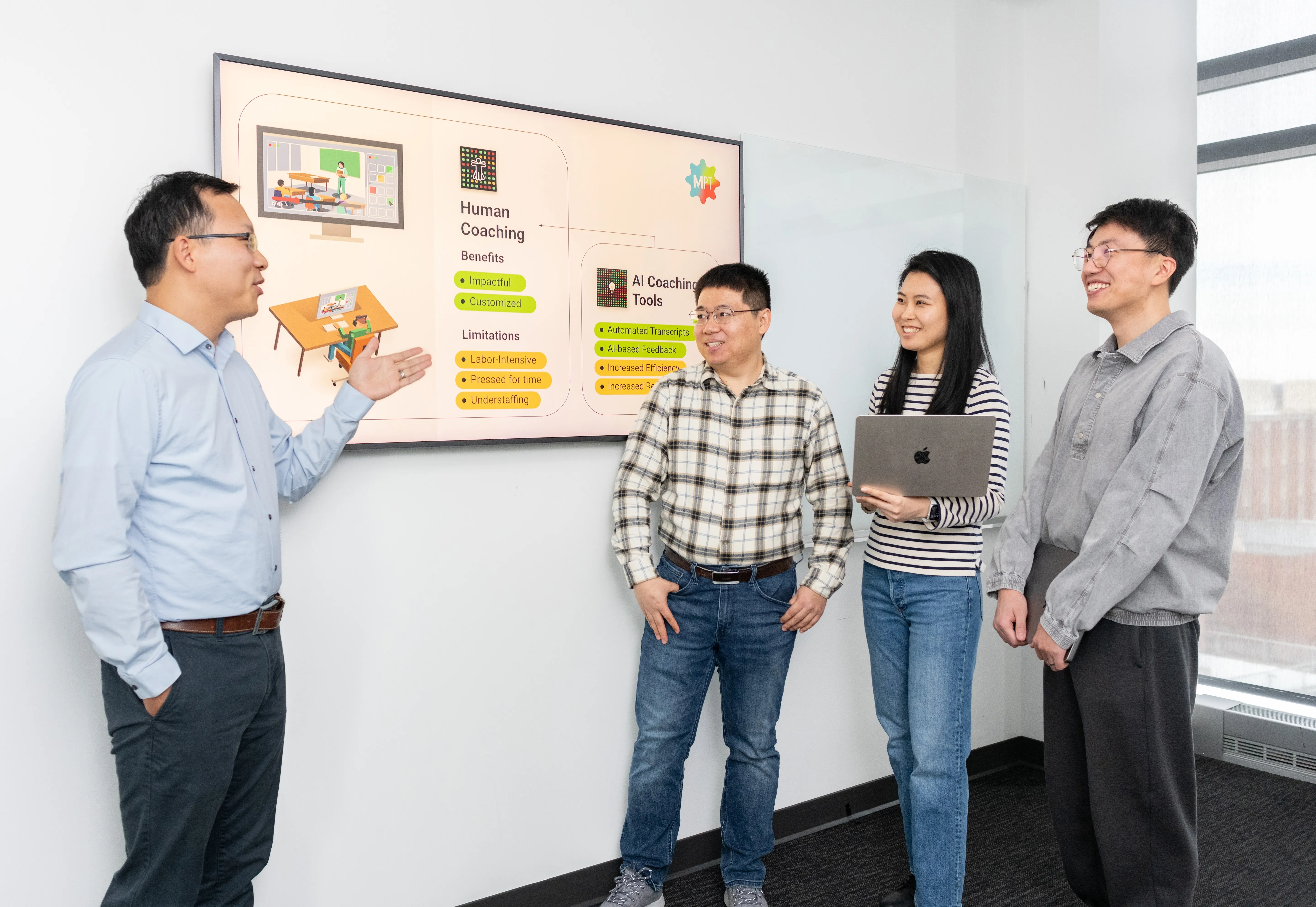 a group of people standing in front of a screen
