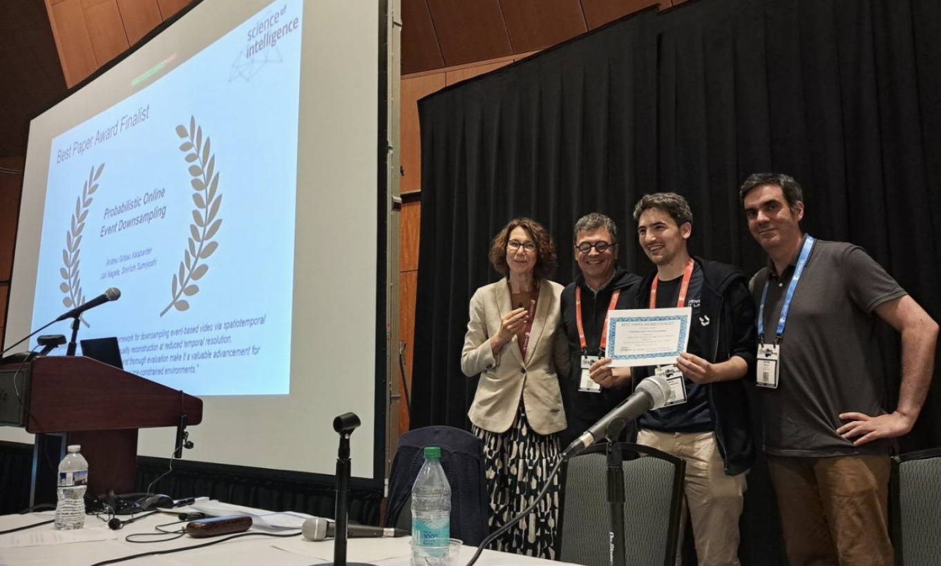 four researchers posing by presentation with certificate