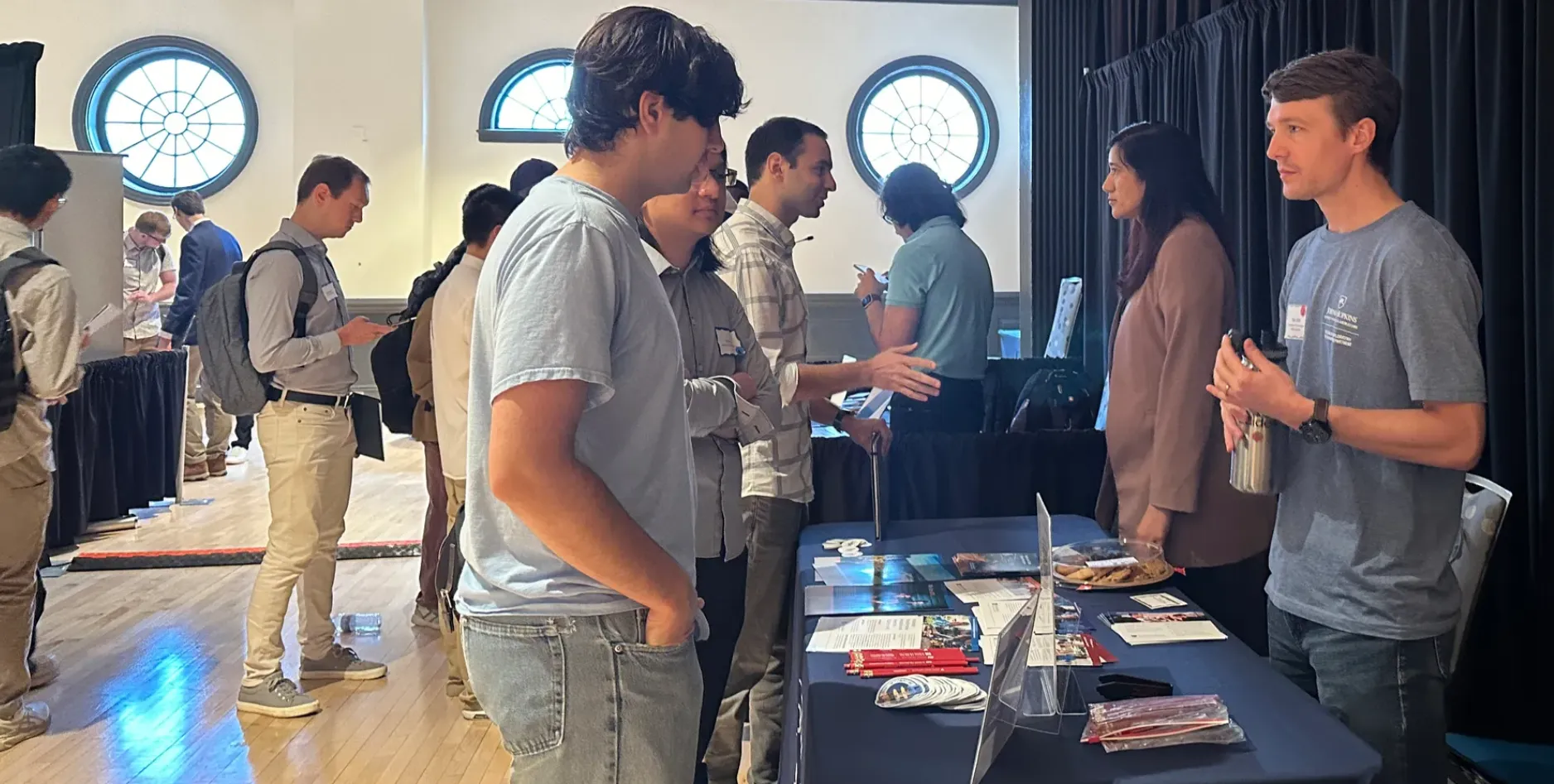 A group of students at a conference talking to each other