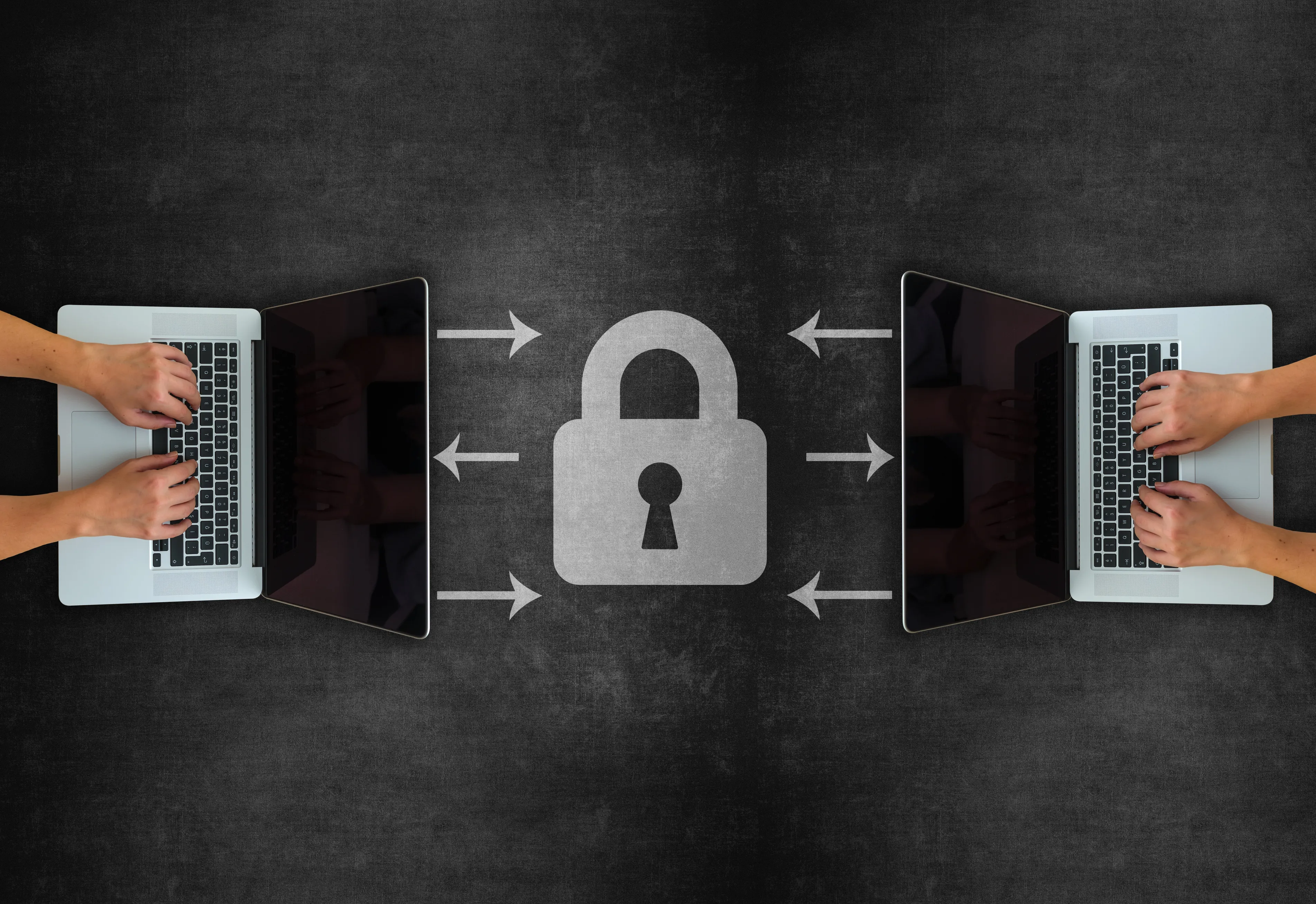 Two laptops with a lock between them.