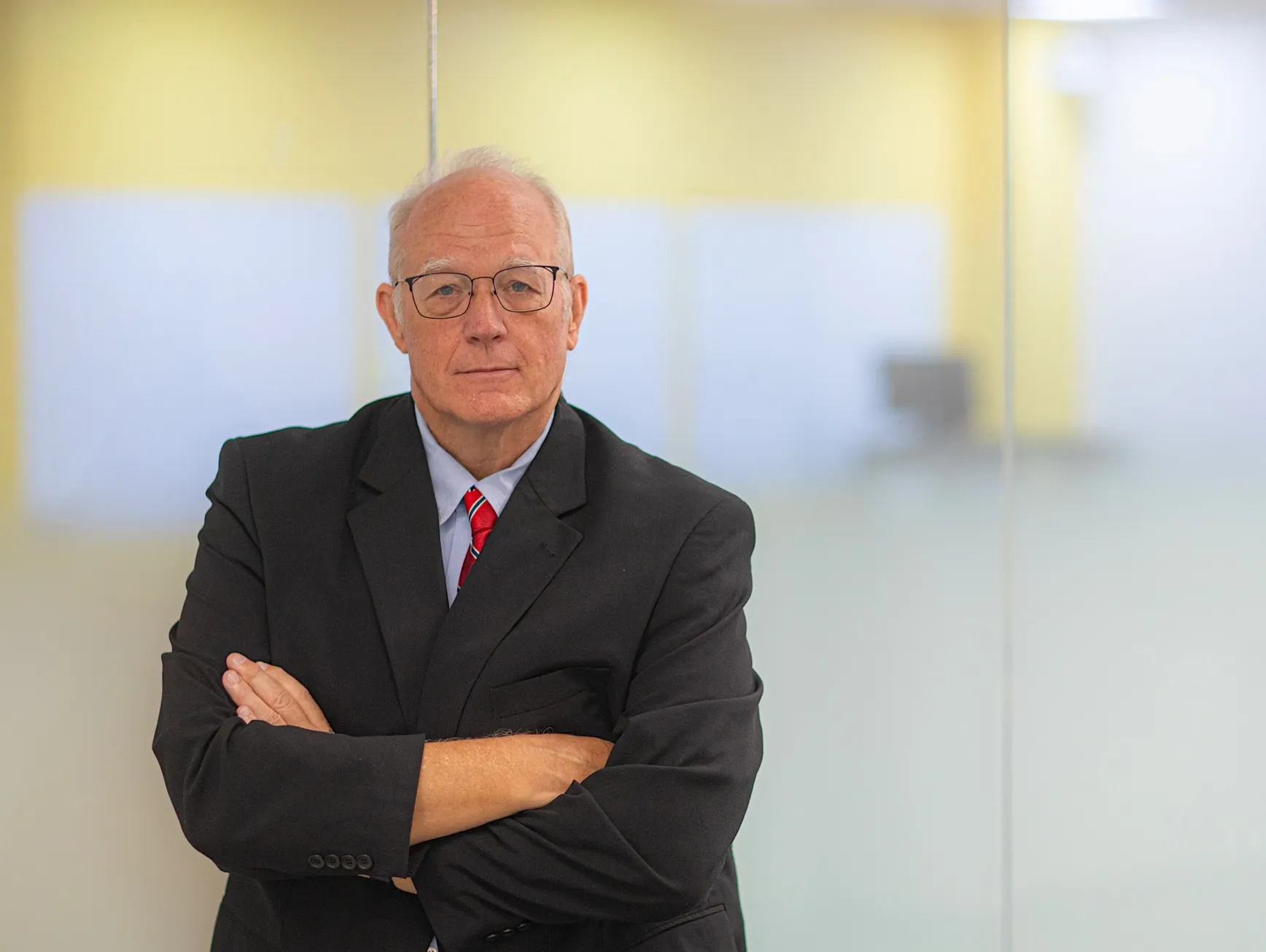 A photo of Doug Oard in front of a yellow background.