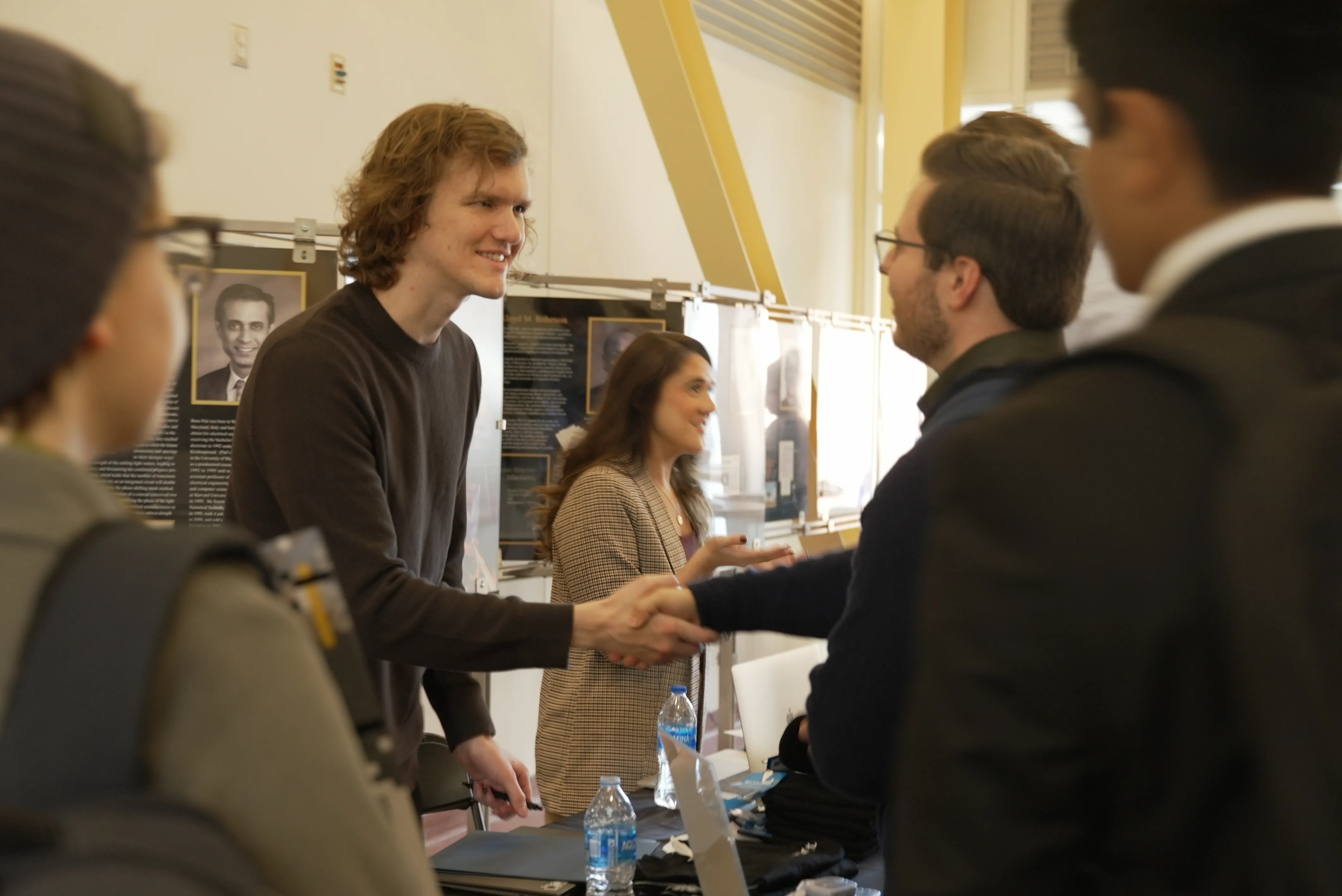 student and man shaking hands at career fair