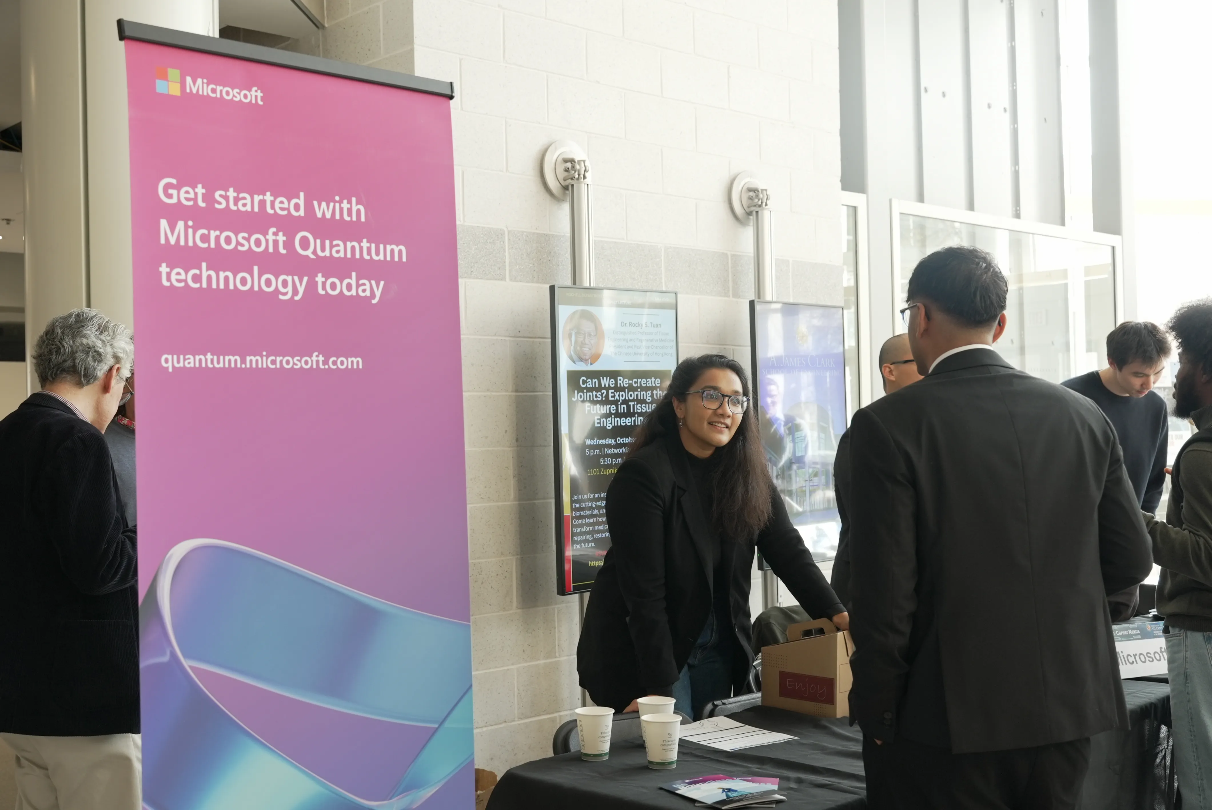 Microsoft quantum sign at career fair tables with people
