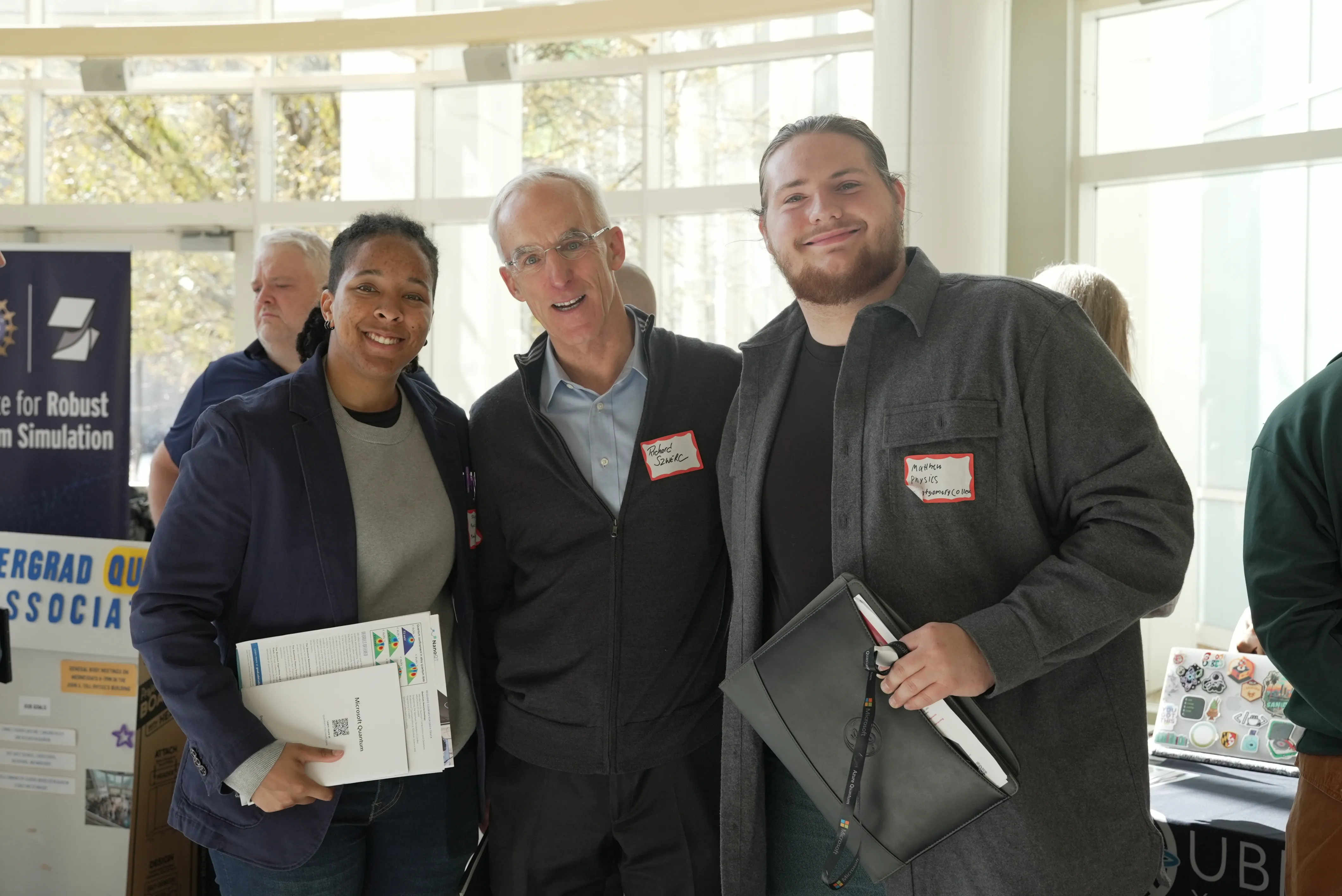 one woman and two men with nametags