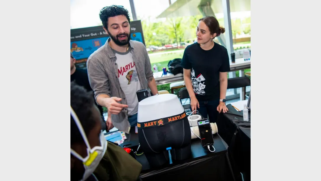 Research Group presenting work at a table