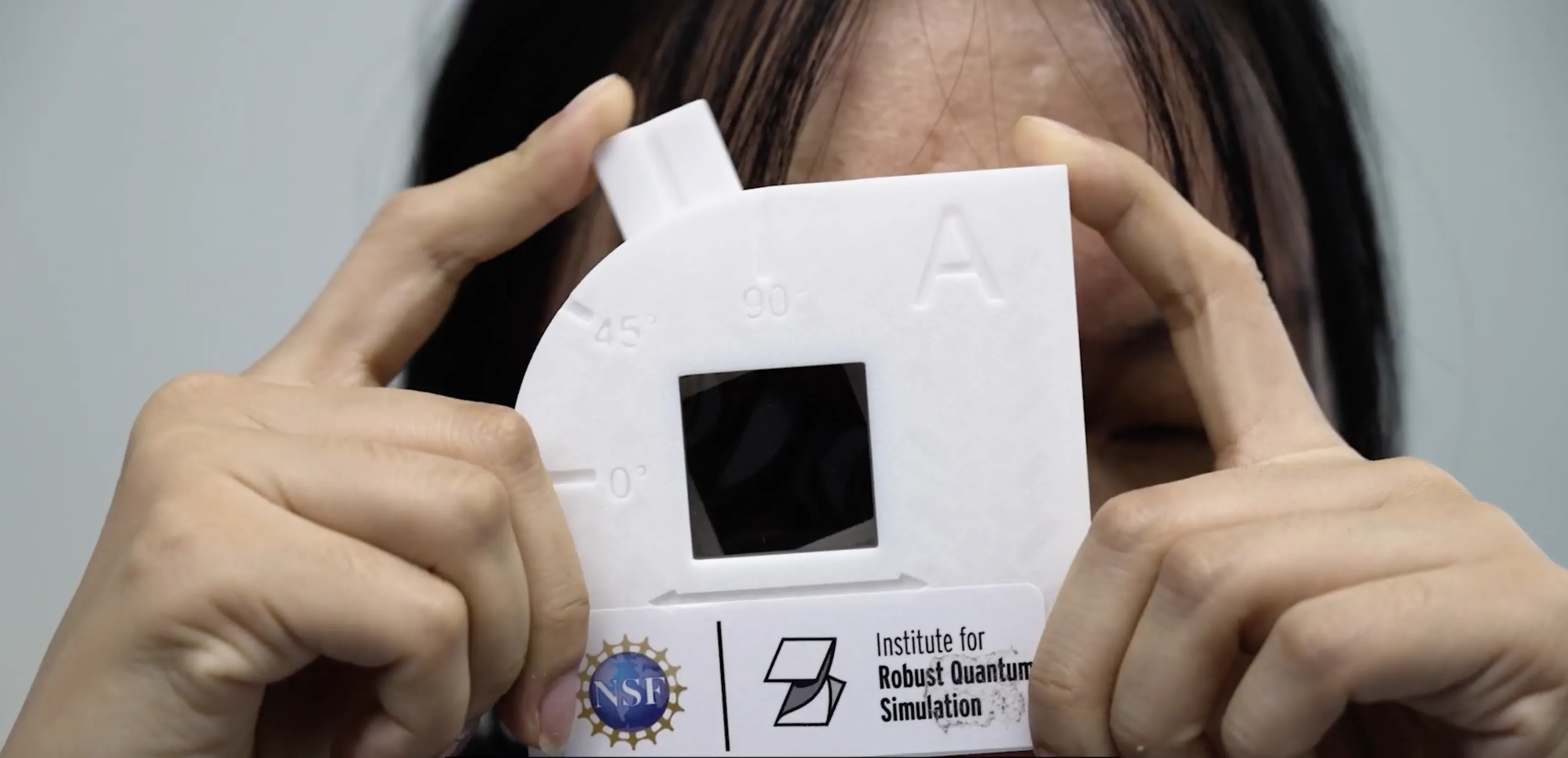 person holding activity kit with RQS logo