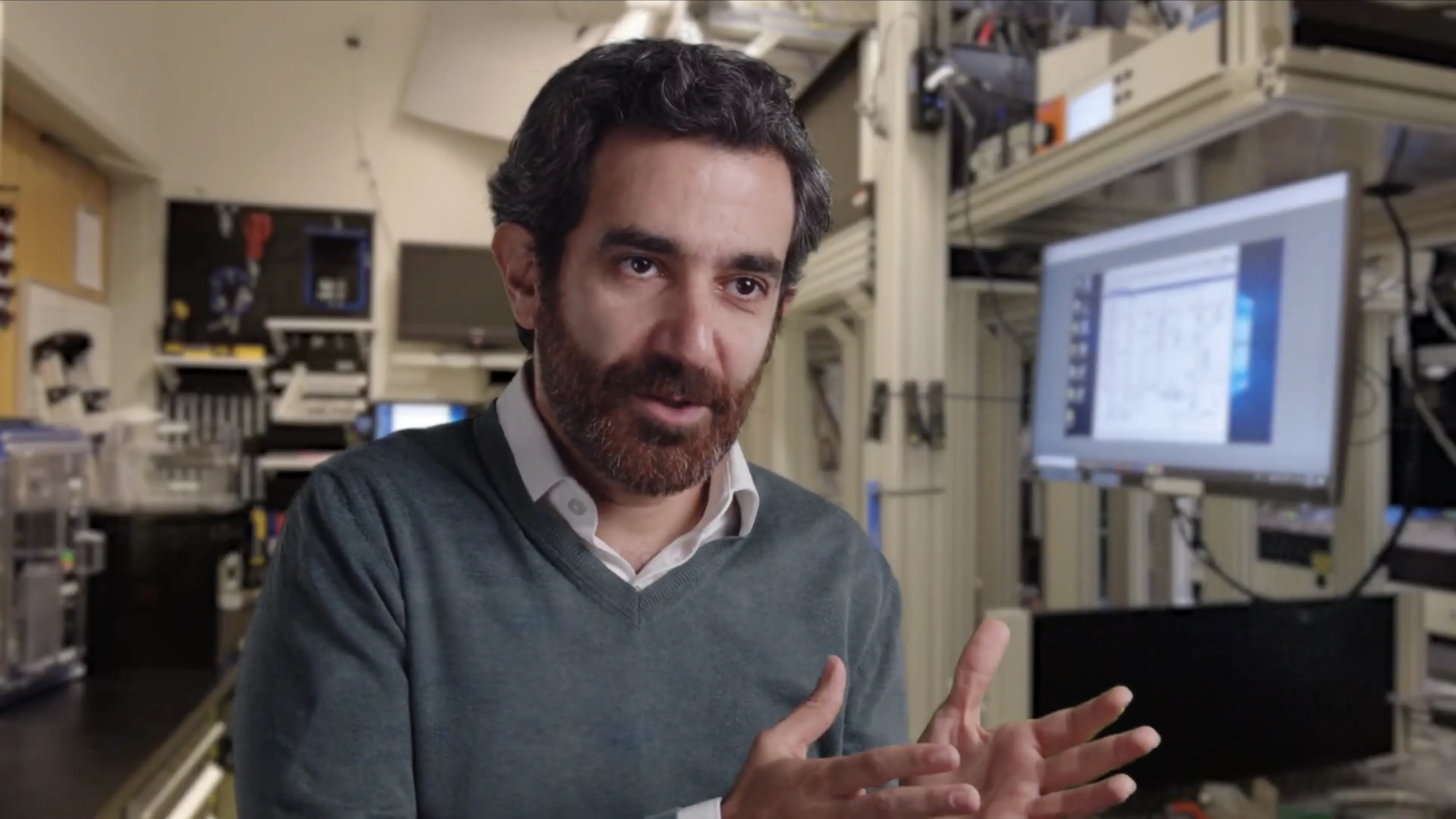 Mohammad Hafezi sits in a laboratory setting, gesturing with his hands while speaking.