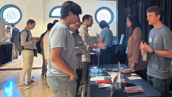 A group of students at a conference talking to each other